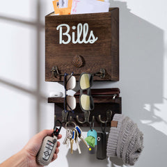 eBun wooden wall mount mail organizer with keys, sunglasses, and a hat on a white wall.