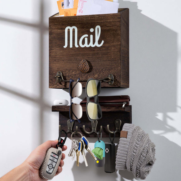 Wooden wall-mounted eBun mail organizer with keys, sunglasses, and a hat on a white background